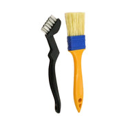 A black grill cleaning brush and a yellow and blue basting brush stand upright on a white background.