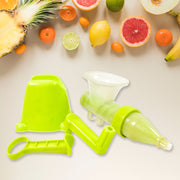 Disassembled green manual juicer parts, including the base, handle, and auger, surrounded by various fresh fruits.