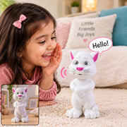 A young girl in a pink shirt smiles at a white cat toy with pink ears and nose, saying 