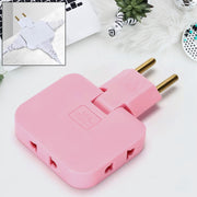 Pink 3-in-1 foldable wall plug adapter on a desk with a laptop and plant. Inset shows a white version with three cords