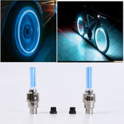 Two blue LED valve cap lights with black adapters, and a car and bicycle with glowing blue wheels.