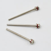 Three silver mandrels with red bands and screw heads lie scattered on a plain white background.