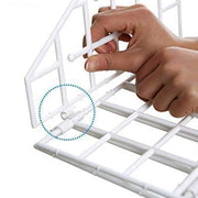 Close-up of hands assembling the white plastic grid pieces of the hanging closet organizer.