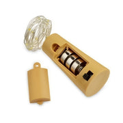 A disassembled bottle cork light showing the tan cork, battery compartment with three batteries, and coiled LED string.