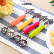 Four colorful dual-ended fruit tools with orange, yellow, pink, and green handles are arranged on a striped cloth next to a