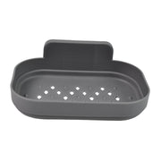 A gray self-adhesive soap dish with diamond-shaped drainage holes is shown on a white background.