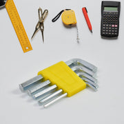 A set of silver hex keys with a yellow holder on a white background, surrounded by other measuring and drawing tools.