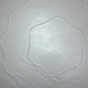 A very close-up, abstract view of the grey stability ball's wavy textured surface, showing a hexagonal pattern.