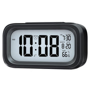 A black digital alarm clock with a white display showing 10:08 AM, 7:30 alarm, date 8.20, and 86.6°F temperature on a white