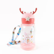 A pink and clear water bottle with a bunny design, deer antlers, and a colorful strap, on a white background