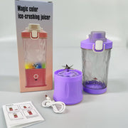 A purple portable blender, its base, a pink blender box, and a USB cable with instructions on a white surface.