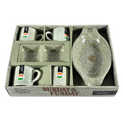 A speckled gray-green ceramic snack and tea set in an open gift box with text.