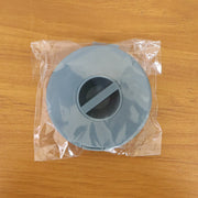 A closed blue cable winder case is sealed inside clear plastic packaging on a wooden surface.
