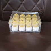A clear plastic box containing twelve gold mesh LED tealights, displayed on a brown textured surface.