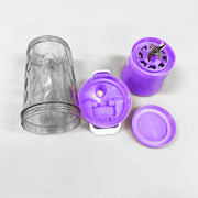 A disassembled purple portable blender showing the clear cup, lid, and base with visible blades.