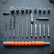 An array of drill bits, screwdriver bits, and socket wrenches neatly arranged on a dark, textured surface.