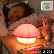 Mushroom night light glowing on a bedside table with a sleeping child and teddy bear in the background.
