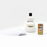 A white ceiling fan base, five fan blades, and a remote control are neatly arranged on a plain white background.