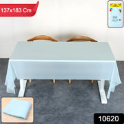 A light blue plastic table cover on a white table, with a folded cover and packaging shown in corners.