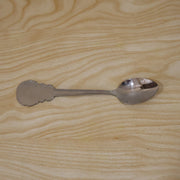 Individually packaged stainless steel carved handle dinner spoon, ideal for gifting.