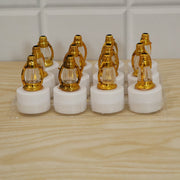 Twelve golden lantern LED candles with white bases are neatly packaged in a clear plastic tray on a light wooden surface.