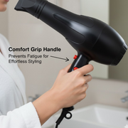 A hand holds a black hair dryer, highlighting the red buttons and text about a comfort grip handle.