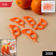 Five orange plastic citrus peelers are displayed on a light brown surface, with two oranges in the background.