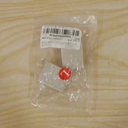 A clear plastic bag containing two beige elastic toe separators and a red circular sticker with the letter 