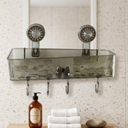 A clear grey plastic caddy with four hooks is mounted on a speckled wall above a wooden counter with soap and towels.