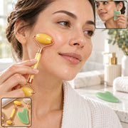 A woman uses a yellow facial roller on her cheek, with insets showing a gua sha tool and the set.