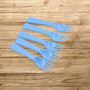 A neatly arranged set of five reusable plastic forks in a clean kitchen setting.
