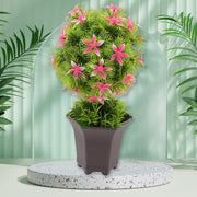 Artificial flower plant with a cute white pot on a wooden surface, enhancing home decor.