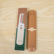 The brown multi-tool case and its packaging box are displayed side-by-side on a light wooden surface.