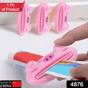 Portable multifunction laptop table with pink pig toothpaste squeezer for home or travel.