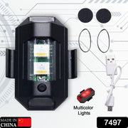 Black LED strobe light, USB cable, two rubber bands, and two round adhesive pads on a grey background.