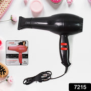 A black hair dryer with red buttons, a product box for a pink hair dryer, and various beauty items on a white surface.