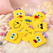 Seven yellow emoji hot water bags with various facial expressions are scattered on a white fluffy rug.
