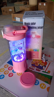 The electric portable juicer glowing with dynamic multicolor lighting effects, enhancing its appeal.