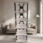 A front view of the light grey and black foldable shoe rack, empty, in a softly lit room with a couch.