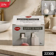 Two white plastic bottle holders with clear adhesive pads on a dark gray tiled wall next to a chrome faucet.