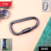 A black D-ring carabiner with screw lock is centered on a peach and teal background with a small inset of the product.
