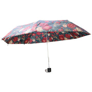 A fully open floral umbrella, featuring red and white flowers on a dark green canopy, is displayed against a plain white