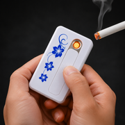 Hands hold a white USB lighter with blue floral pattern, igniting a cigarette with a glowing orange coil.