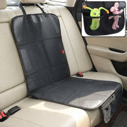 A black car seat protector with pockets for toys is draped over a beige car seat, ready for use.