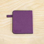 A closed purple bifold wallet with the brand name 