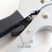 Close-up of the pruning shears' lock/unlock mechanism with a textured black switch.