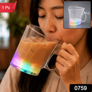 A person sips an iced coffee from a clear heart-shaped mug with a rainbow-lit base. A red '1 Pc' label is in the top left.