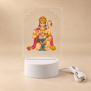 A Hanuman LED acrylic night lamp with its white base and USB cable, presented on a light neutral background.