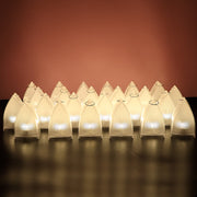 Twenty-four transparent arch stripe LED candles with a subtle glow, arranged in rows against a light pink background.