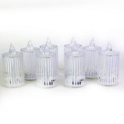 Eight clear ribbed LED flameless candles unlit, arranged on a plain white background.